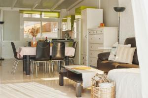 a kitchen and living room with a table and chairs at Urban Harmony Nest in Arona