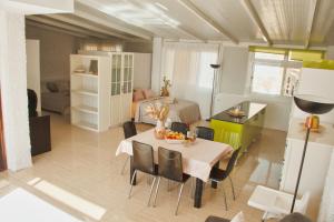 a living room with a dining table and a bedroom at Urban Harmony Nest in Arona +18 photos