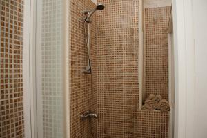a bathroom with a shower with a shower head at Urban Harmony Nest in Arona
