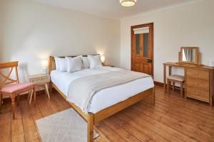 a bedroom with a bed and a table and a chair at Host & Stay - The Orchard in Cramlington