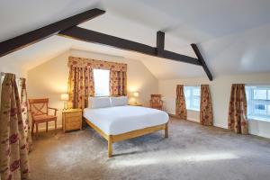 a bedroom with a white bed and two windows at Host & Stay - The Orchard in Cramlington