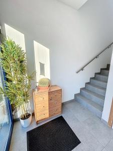 a room with stairs and a wooden dresser and a staircase at NOMAD APARTMENTS - Duplex de l'abbaye 