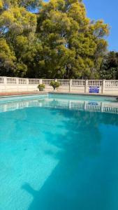 a large pool of blue water with a fence at Luxurious suite with outdoor pool - 2171 in Bulawayo