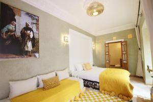 a hotel room with a bed and a couch at Riad Chez Henriette in Marrakesh