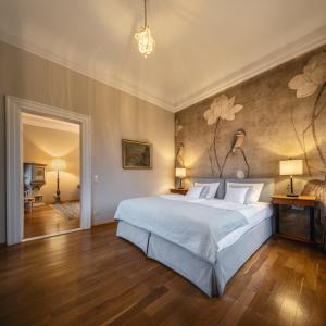 1 dormitorio con 1 cama grande y una pared con flores en Zamek Karpniki Schloss Fischbach en Łomnica
