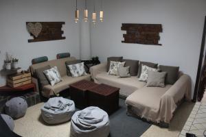 a living room with two couches and a table at Finca Esther in Las Palmas de Gran Canaria +41 photos