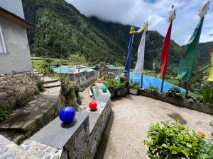 a patio with a view of a pool with flags at Mount kailash lodge and resturant , Monjo in Monjo