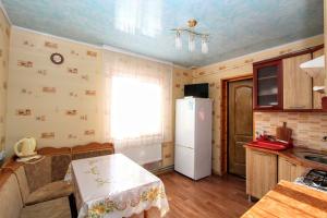eine Küche mit einem weißen Kühlschrank und einem Fenster in der Unterkunft Котедж "Райський куточок" in Jaremtsche