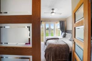 a bedroom with two beds and a flat screen tv at Farm stay outside Canterbury in Stelling