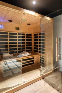 a room with a sauna with a glass wall at Business Hotel Maier - kontaktloser Check-in in Götzis