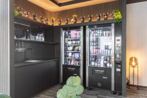 a bar with two refrigerators with drinks in them at Business Hotel Maier - kontaktloser Check-in in Götzis