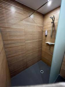 a shower with a glass door in a bathroom at Boarding House am Ahnepark in Vellmar
