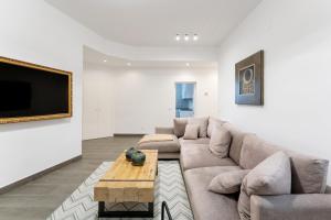 a living room with a couch and a coffee table at Luxe Apartment in Plaza de España in Madrid
