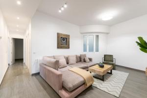 a living room with a couch and a table at Luxe Apartment in Plaza de España in Madrid