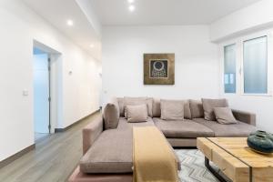 a living room with a couch and a table at Luxe Apartment in Plaza de España in Madrid