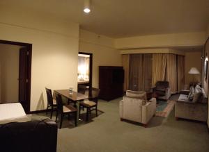 a living room with a table and chairs and a dining room at CITY APARTMENT at TIMES SQUARE in Kuala Lumpur