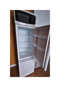 an empty refrigerator with its door open in a room at SOBO Studio in Bournemouth