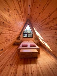a room with a bed in a log cabin at Popovic SPA house Tara in Ljuboš