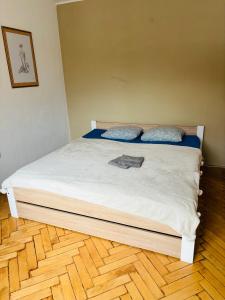 a bed with two pillows on top of it at Provence style apartment in Košice