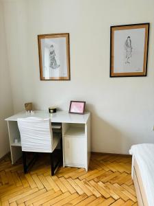 a desk and a chair in a room with a bed at Provence style apartment in Košice