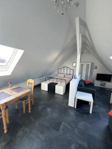 a living room with a bed and a table and chairs at Ferienwohnung FENJA in Bonerath