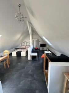 a living room with couches and tables and a chandelier at Ferienwohnung FENJA in Bonerath +14 photos
