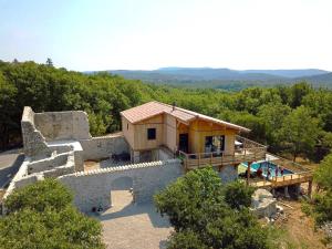 a house on top of a hill with a pool at Mas GEORGES in Saint Alban Auriolles