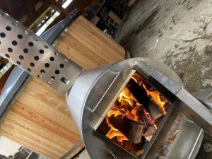 a pizza oven with a fire inside of it at Chata Matej in Námestovo