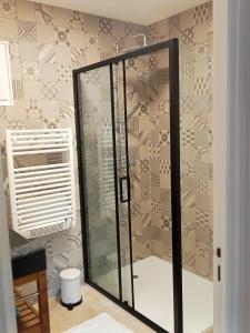a shower with a glass door in a bathroom at Maison Bohème Vesubie in La Bollène-Vésubie