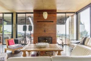 a living room with a table and a fireplace at Luxury Stay at Bakish Peaks Villa with pool 