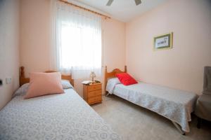 a bedroom with two beds and a window at Chalet individual con piscina privada en Miami Playa in Miami Platja +22 photos