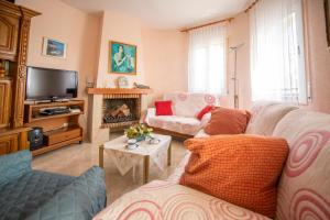 a living room with two couches and a fireplace at Chalet individual con piscina privada en Miami Playa in Miami Platja