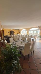 a large dining room with a table and chairs at Hotel Las Camelias in Sotogrande