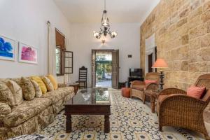 a living room with a couch and a table at La Madrague 3 Bedroom Villa with Garden in Batroun in Batroûn