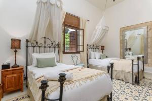 a bedroom with two beds and a mirror at La Madrague 3 Bedroom Villa with Garden in Batroun in Batroûn