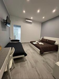 a bedroom with a bed and a couch and a table at Giufra in Bari