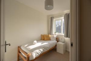 a small bedroom with a bed and a window at Pottery Wharf By Horizon Stays in Thornaby on Tees