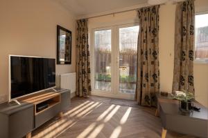 a living room with a television and a large window at Pottery Wharf By Horizon Stays in Thornaby on Tees