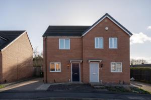 a red brick house with a black roof at Pottery Wharf By Horizon Stays in Thornaby on Tees