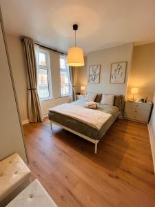 a bedroom with a bed and a large window at J&S Downtown Sky Attic House in Belfast