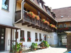 a building with potted plants on the balconies at Pension "Zur Lohgerberei" in Bad Langensalza