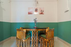 a dining room with a table and two chairs at Mulaqat Homestay in Siliguri