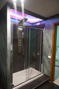 a shower with a glass door in a bathroom at On The Rainbow B&B in Rome