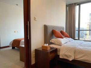 a hotel room with a bed and a window at River House Near The Peoples Square And The Bund in Shanghai