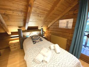 a bedroom with a bed in a wooden cabin at LE LOUP Chalet en bois in La Bresse