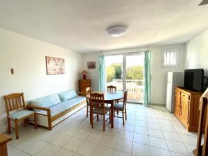 a living room with a couch and a table at La Maison sur la côte in Fleury
