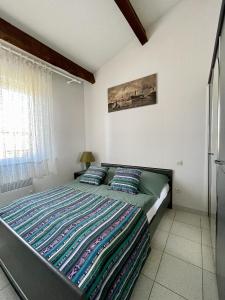a bedroom with a large bed with two pillows at La Maison sur la côte in Fleury