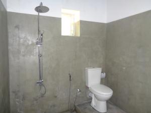 a bathroom with a toilet and a shower at Green Valley Home stay in Talpe