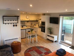a living room with a kitchen and a table at The Studio in Harrogate