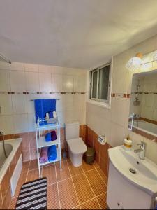 a bathroom with a toilet and a sink and a tub at Urban Retreat - Your Ideal Getaway in Limassol in Limassol